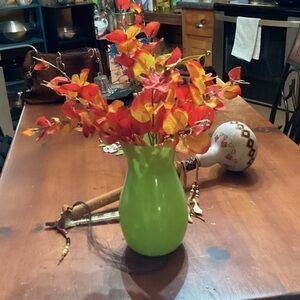 Vibrant Green Vase with Red and Orange Floral Arrangement